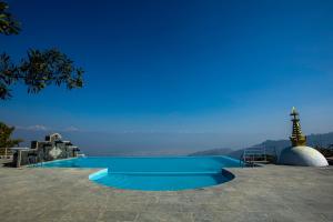 a swimming pool with a view of the ocean at Dhulikhel Lodge Resort in Dhulikhel