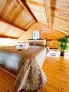 a bedroom with a bed in a wooden cabin at Elleria's House in Lefkada Town