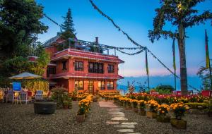 a building with a bunch of flowers in front of it at Dhulikhel Lodge Resort in Dhulikhel