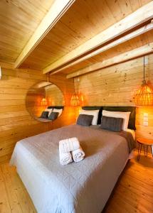 a bedroom with a bed with two towels on it at Elleria's House in Lefkada