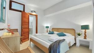 a bedroom with a bed with blue pillows in it at La Maranita Apartment in La Maddalena