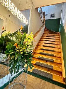 a staircase with a bunch of flowers in a building at CIENISTA 7 APARTMENTS in Lądek-Zdrój