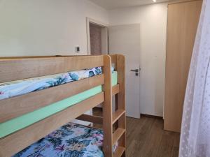 two bunk beds in a room with a door at Adel apartment in Izola