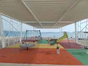 a play area at the beach with a playground at Apartman Perkovic in Šibenik