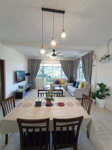 a dining room and living room with a table and chairs at Dream 1 in Cameron Highlands