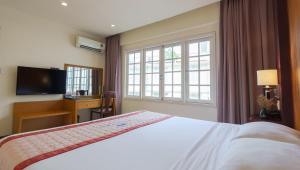 a bedroom with a bed and a large window at Petro House Vung Tau - Block B in Vung Tau +35 photos