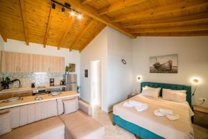 a large bedroom with a bed and a kitchen at Elena's Seaside Apartments & Studios in Agios Gordios