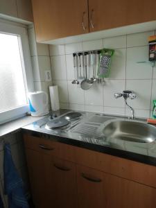 a kitchen with a sink and a counter top at FEWO Isla 1 in Elmenhorst