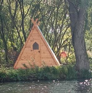 a bird house in the middle of some trees at Teeny Tiny Tipi lakeside pod in Clare