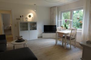 a living room with a table and a television at Ferienwohnung Hankeln in Winterberg