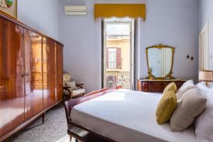 a bedroom with a large bed and a window at Rettifilo Family Apartment by Wonderful Italy in Naples