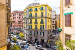 a yellow building on a street in a city at Rettifilo Family Apartment by Wonderful Italy in Naples