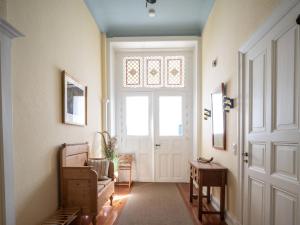 a hallway with a door and a chair and a window at Ostseevilla Eckernförde in Eckernförde