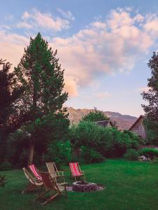 a group of three chairs sitting in a yard at Hotel Aquamarin in Bad Mitterndorf