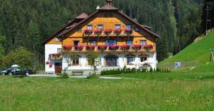 a house with flower boxes on the front of it at Pension Glöshof in Ramsau am Dachstein