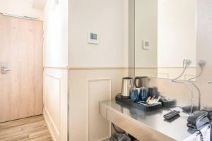 a kitchen with a counter with a coffee maker on it at District Republique in Paris