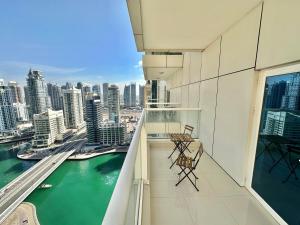 a balcony with chairs and a view of the city at Dubai Marina Continental tower in Dubai