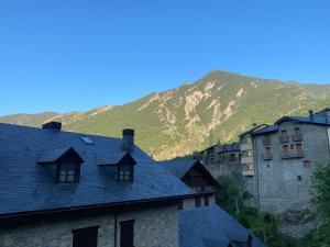 un grupo de casas con una montaña en el fondo en Era de Caçador, en Llavorsí