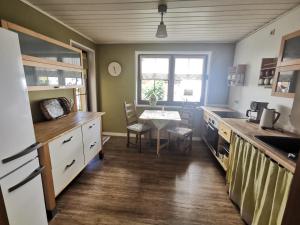 a kitchen with a table and a dining room at Gartenwohnung Paulsdorf in Dippoldiswalde