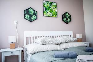 a bedroom with a bed and two pictures on the wall at Centergom in Esztergom