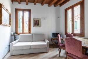 un soggiorno con divano bianco e scrivania di Venice Love Suite a Venezia