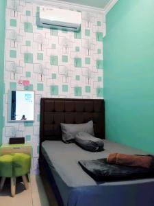 日惹的住宿－De Patuk Homestay，一间卧室设有一张床和鲜花墙