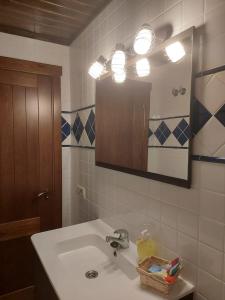 W łazience znajduje się umywalka i lustro. w obiekcie Casa las Torres w mieście Mora de Rubielos