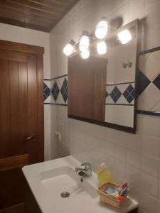 a bathroom with a sink and a mirror at Casa Las Torres in Mora de Rubielos +16 photos