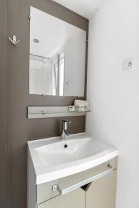 a bathroom with a white sink and a mirror at Camping El Pinar in Blanes