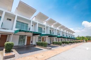 a large white building with a row of windows at Tasik Villa International Resort in Port Dickson