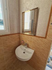 a bathroom with a sink and a mirror at Yasin White villa in Gabala