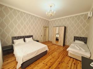 a bedroom with a large bed and a mirror at Yasin White villa in Gabala