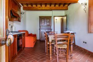 a kitchen with a table and chairs and a couch at Casa Vacanza Il Carpignone 2 in Massa Marittima