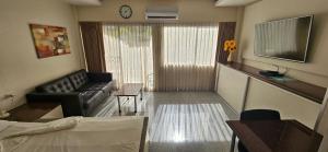 a living room with a couch and a table at Oasis Rentals, Diana Estate, Pattaya in Pattaya Central +11 photos