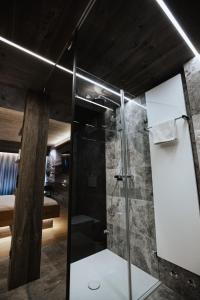 a bathroom with a shower with a glass door at Hotel Gleiserei in Oberndorf bei Salzburg