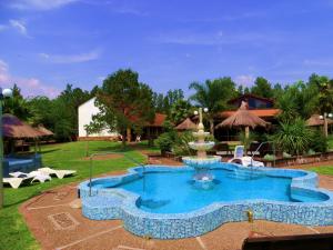 a pool at a resort with a fountain at Casa de Piedra in Termas del Daymán