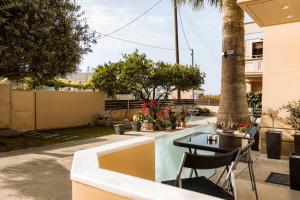 a patio with a table and chairs in a yard at Plakoures Home in Kounoupidhianá