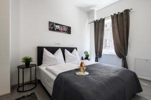 a bedroom with a large bed and a window at City Rooms OS in Osijek