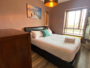 a bedroom with a bed with a laptop on it at The Stillorgan Village in Dublin