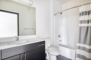a white bathroom with a sink and a toilet at Bellevue 2BR w BBQ Gym WD walkable area SEA-315 in Redmond +25 photos