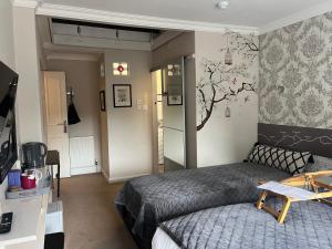 a bedroom with a bed and a table in it at Cambridge House room only accommodation for Adults in Windermere