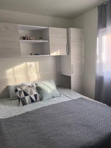 a bedroom with a large bed with white walls at Green Turtle Holiday - Lovely, brand new holiday home near the sea in Drage