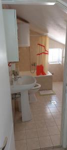 Un baño con lavabo y cortina de ducha. en Apartments Iva i Marko, en Marina