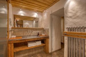 a bathroom with a sink and a mirror at Le Vieux Chalet in La Clusaz