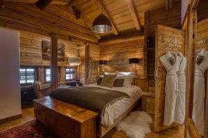a bedroom with a bed in a log cabin at Le Vieux Chalet in La Clusaz