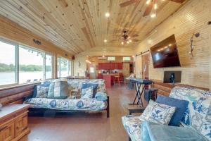a living room with two couches and a kitchen at Rock River Hideaway on Private 5-Acre Island! in Oregon