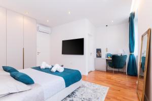 a bedroom with a large bed and a tv at Luxury rooms Volat Old Town in Zadar