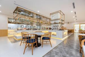 a kitchen with a table and chairs in a room at Petro House Vung Tau - Block B in Vung Tau