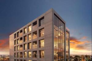 a large office building with many windows at dusk at Luxury 2 Bedroom En-Suite Apartment Balcony Views in Manchester