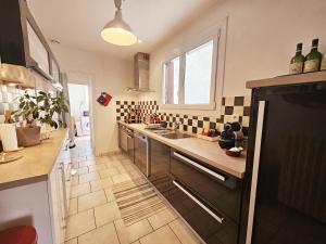 a kitchen with a sink and a counter top at Maison de ville confortable avec cour interieure in Angoulême